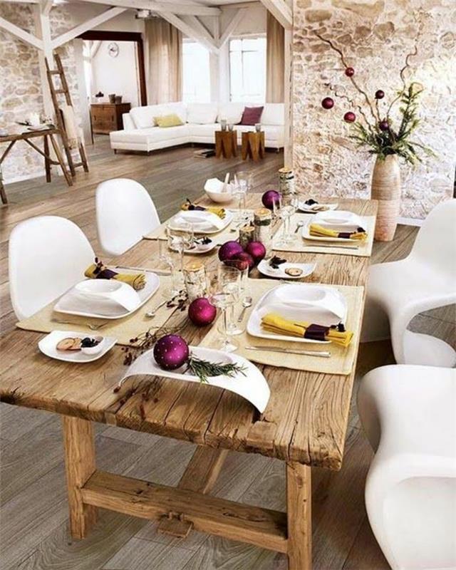 Sala da pranzo con un tavolo decorato con baline viola natalizie
