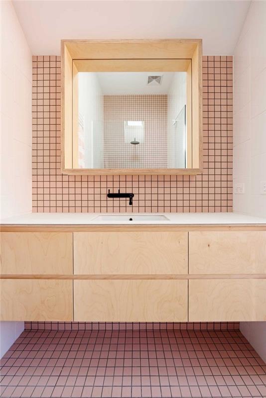 Vintage görünümlü bir banyo için pembe karo zemin ve duvar kaplaması, fonksiyonel bir ayna rafı ile ilişkili doğal ahşap kaplamalı makyaj ünitesi