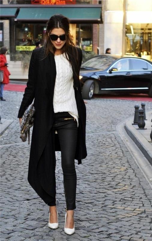 moteriško stiliaus darbo apranga su juodos odos kelnėmis ir ilgu paltu