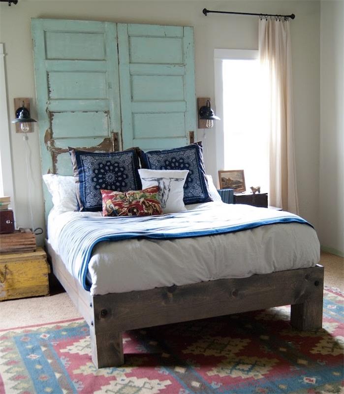 kako narediti vzglavje v recikliranih modrih lesenih vratih, modro -belo posteljnino na leseni postelji, pisano orientalsko preprogo, eleganten vintage dekor spalnice