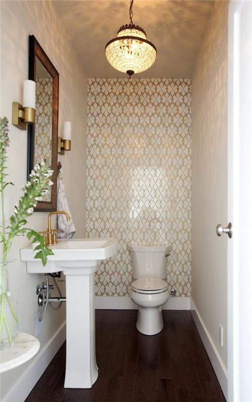 mažos erdvės tualetas, rytietiško stiliaus lubų šviestuvas, tamsios medinės grindys, įrėmintas veidrodis, auksinis čiaupas