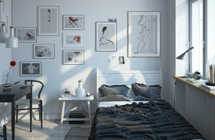 a-minimalistinė-lova-su-medine galvūgaliu-naudota-pilka-pagalvė-stalai-ir-kėdės-pilka spalva-ir-keli grafiniai stalai