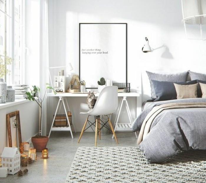 a-skandinaviškas-miegamasis-lova-su pilkomis antklodėmis-šviesiai pilka-kiliminė danga-baltas-stalas-ir-skandinaviška-kėdė-skandinaviška-apdaila-su daugybe deko detalių
