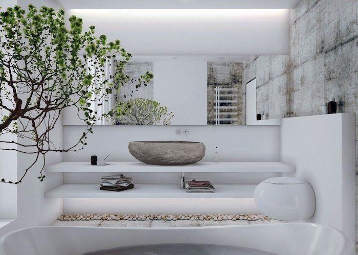 pilkas natūralaus akmens praustuvas baltoje vonios kambario sienoje iš travertino medžio deko