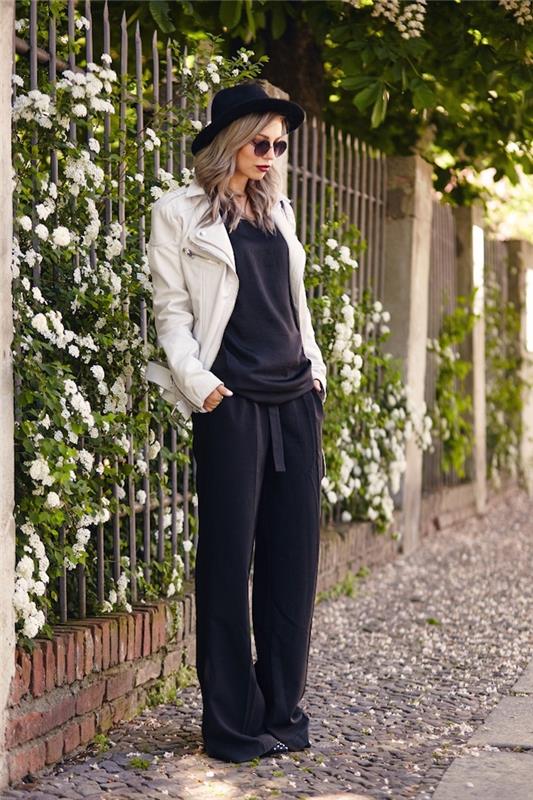 grunge videz, ohlapne črne hlače in bluza, kodrasti lasje srednje dolžine s črnim ogrinjalom