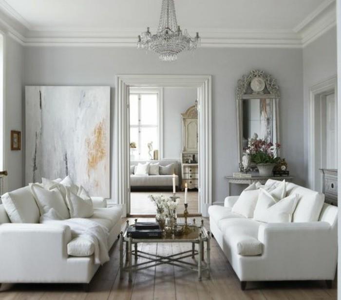baltos sofos, metalinis žurnalinis staliukas, abstraktus menas, pilki svetainės baldai, medinės grindys