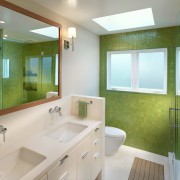 Interior de baño luminoso con una combinación de tonos blancos y verdes.